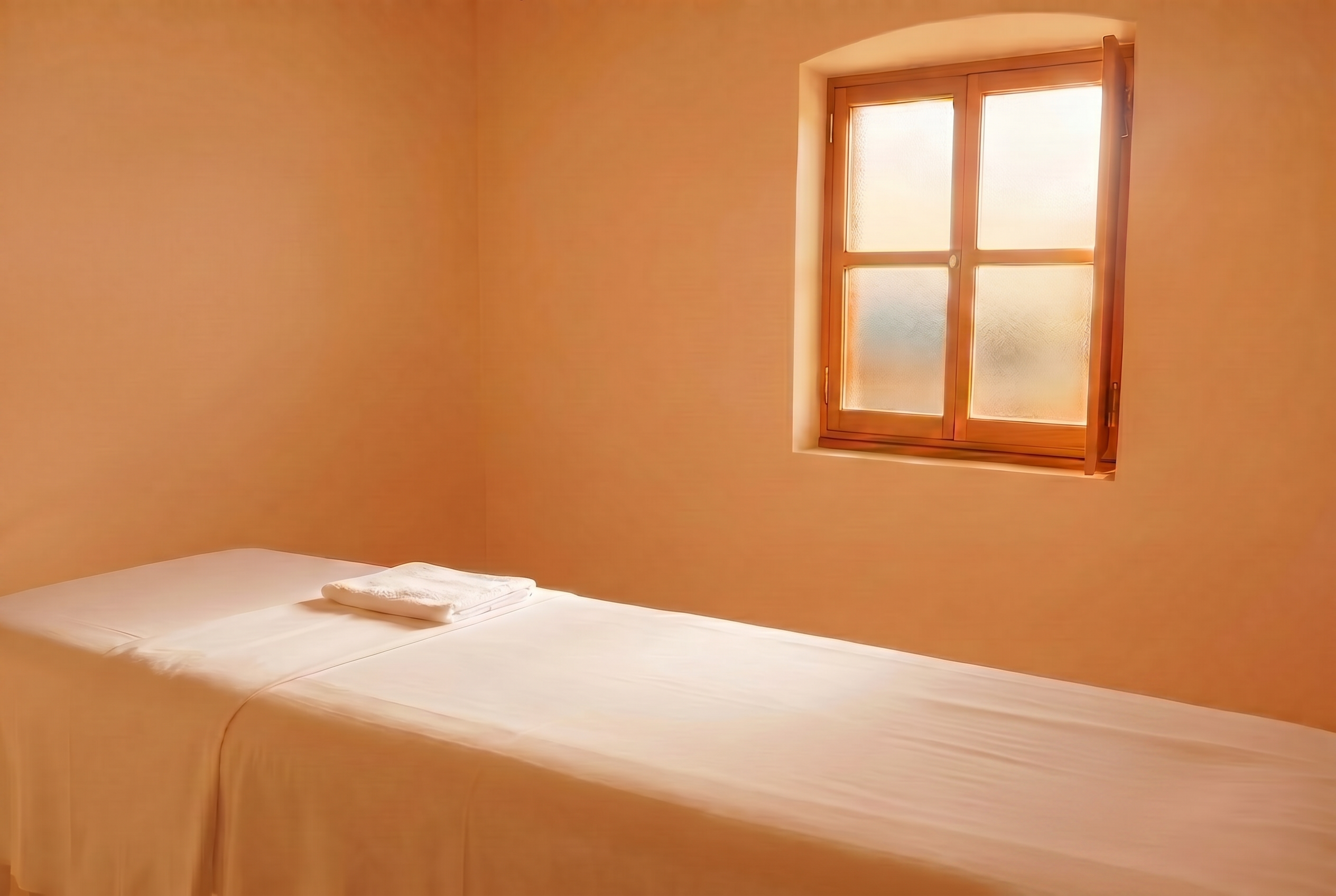 Sunlit massage therapy room with warm light